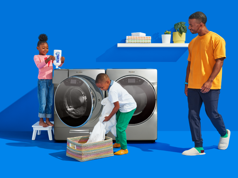 Family in laundry room doing laundry Family in laundry room doing laundry