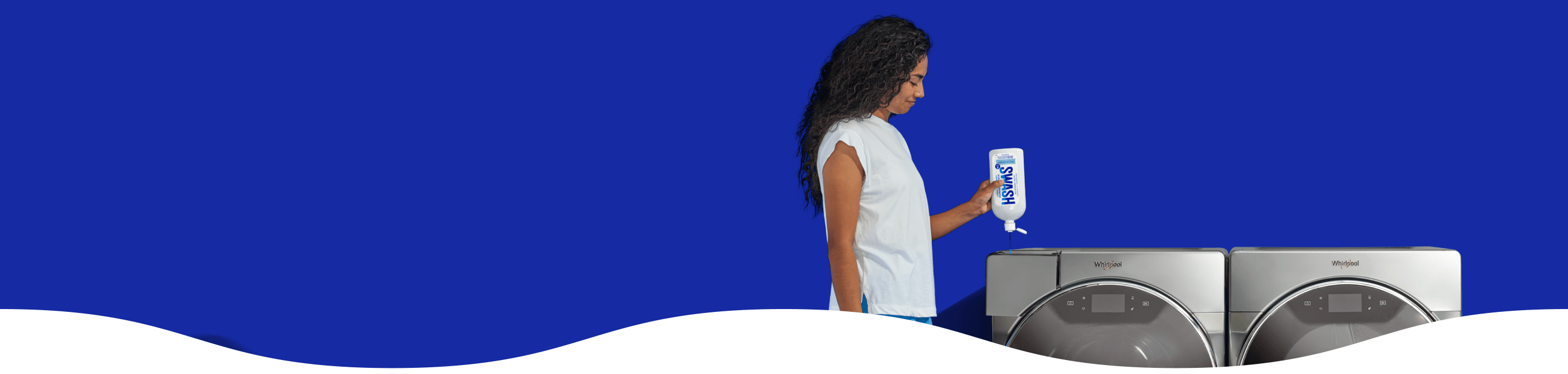 Woman in a gray sweatshirt dispensing Swash laundry detergent using the Precision Pour Cap into a Whirlpool washing machine