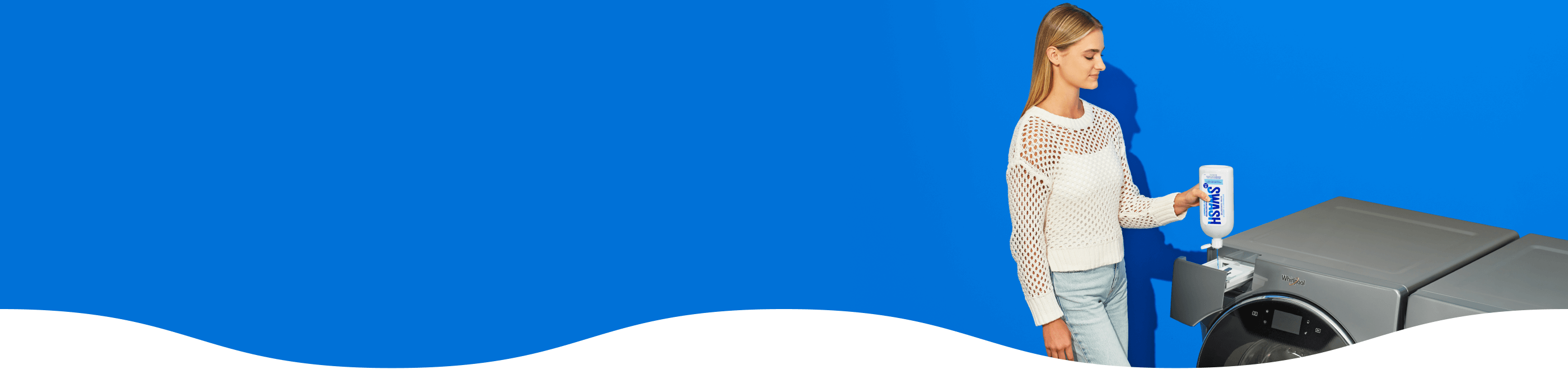 A person filling a Whirlpool® front load washer with Swash® Laundry Detergent.