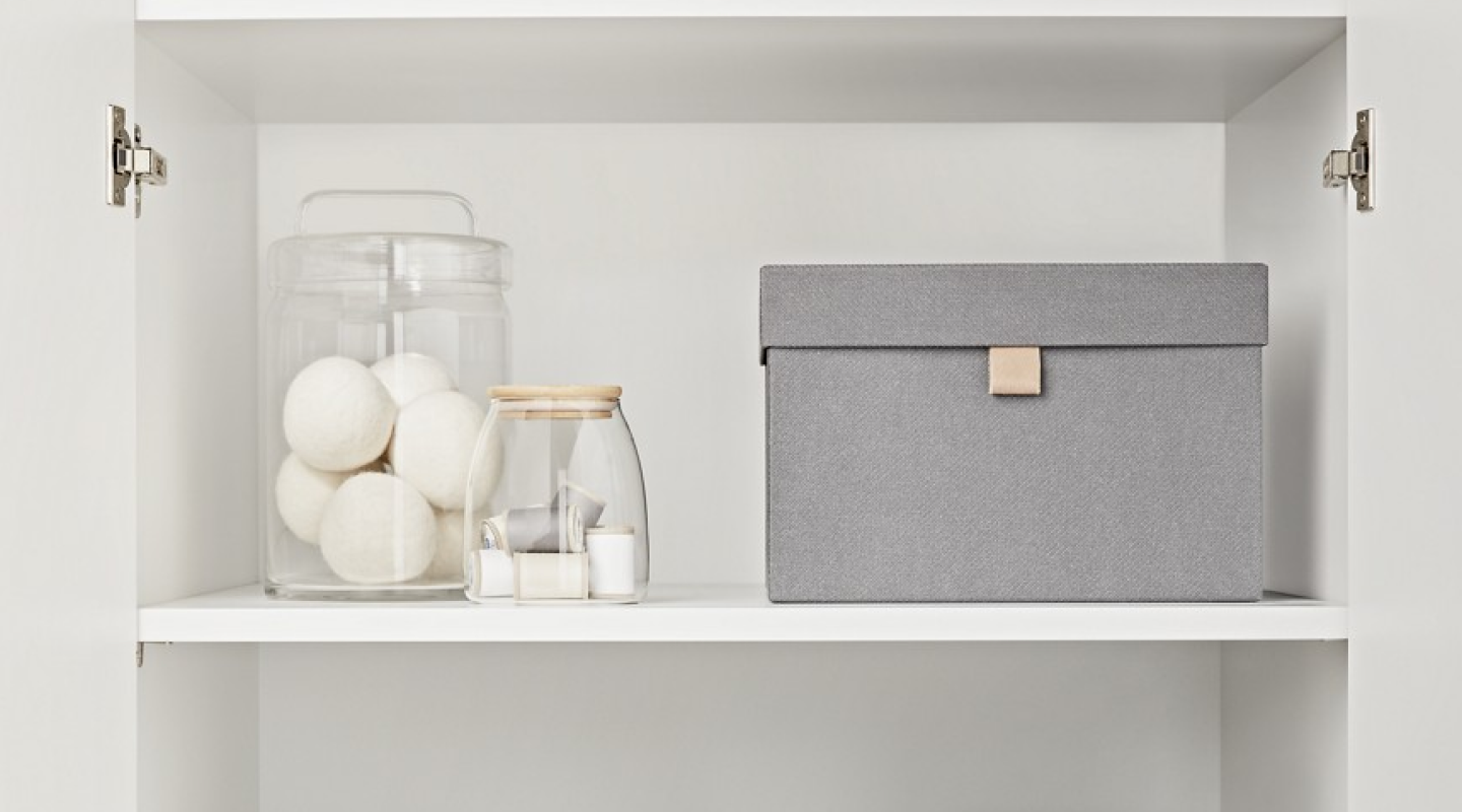 A neatly organized laundry room cabinets.