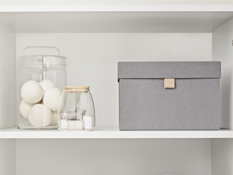 A neatly organized laundry room cabinets.