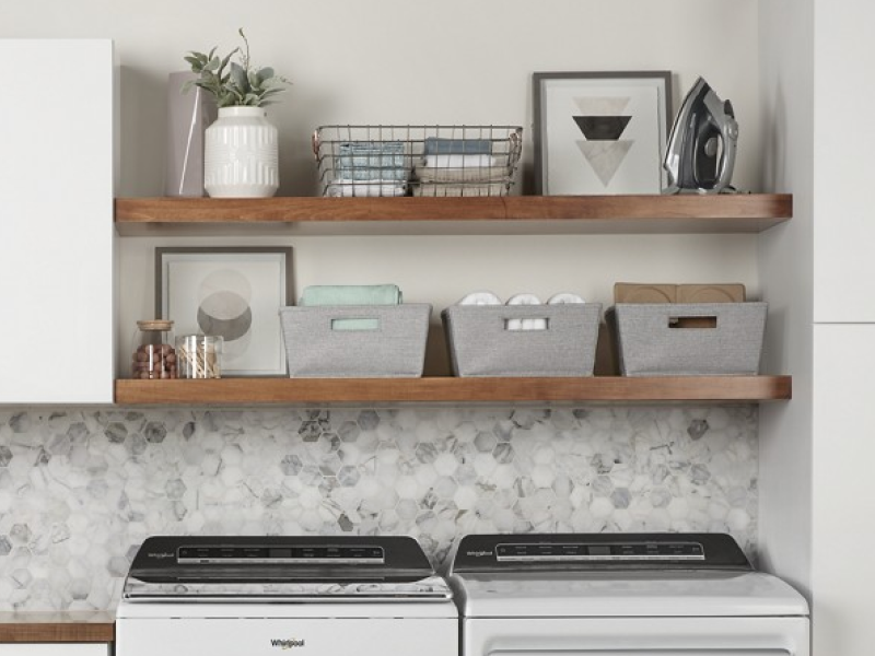A neatly organized launndry room with a Whirlpool® waaher and dryer. A neatly organized launndry room with a Whirlpool® waaher and dryer.