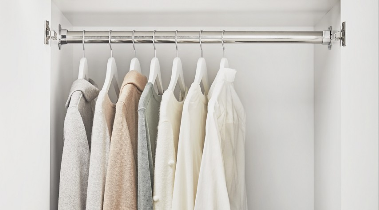 A cabinet in a laundry room with hanging space to dry and organize your clothes. A cabinet in a laundry room with hanging space to dry and organize your clothes.