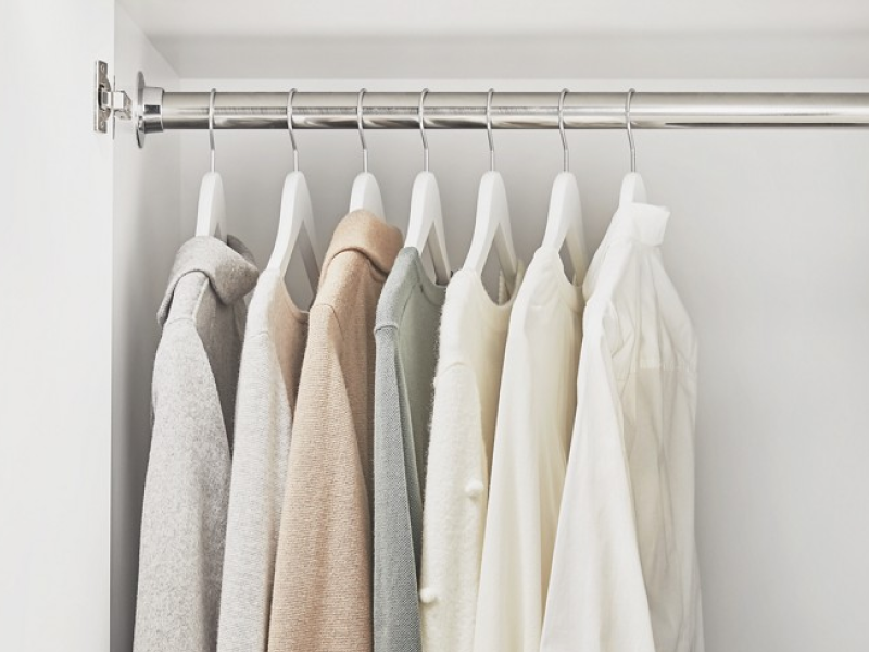 A cabinet in a laundry room with hanging space to dry and organize your clothes. A cabinet in a laundry room with hanging space to dry and organize your clothes.